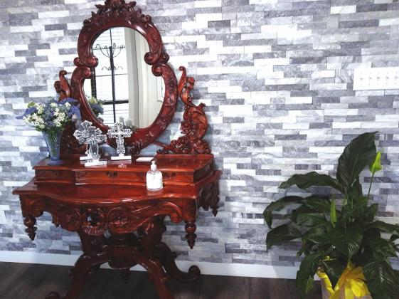 Entryway with antique mirrored table and Peace Lily plant