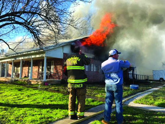 While flames were blazing from the attic, the smoke could be seen for miles and miles.