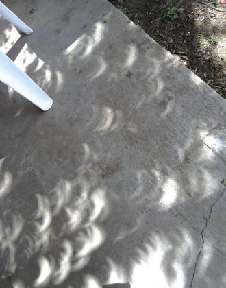 These photos were taken during the Total Solar Eclipse event on Monday, April 8, 2024. The left photo was as the eclipse started. The right photo is later during the event. We were told ahead of time that shadows would look weird, but we never expected this! Photos by Carolyn Boswell-Preece