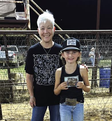 Pee Wee All- Around Cowgirl is Swazee Yancy. Awarding her buckle is director Paula Miller.
