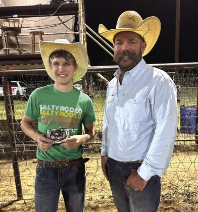 Director John Hert presented Brody Harris with his Champion Bull Riding Buckle.