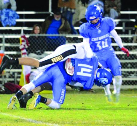 Cherokee Indian Matt Gass making the tackle while Gunner Baugh looks on during the Bi-District game against Blanket. Courtesy of Rita Boultinghouse