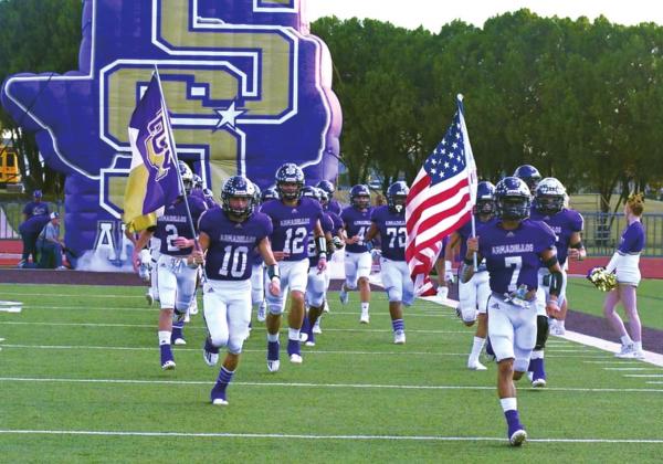San Saba High School varsity football seniors, Wesley Lackey (10) and Franco Franco (7), lead their teammates onto the field on Friday, October 7th, prior to the Armadillos' District game against rival Goldthwaite High School at neutral site Gordon Wood Stadium in Brownwood. (Photo courtesy of Rita Boultinghouse)