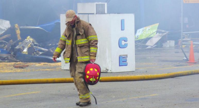 Jack Blossman, Captain of SSVFD, walks slowly in exhaustion across the parking lot for an interview with this editor after finally combating the Lowe's Market fire this past Friday, March 20th. This camera caught the Captain in its lens but several other very tired VFD firemen were trailing behind him. Photo by Donna Webb