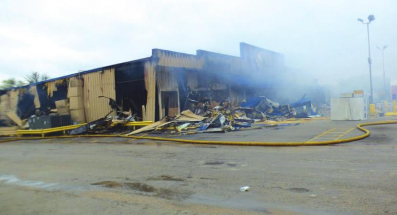 Shown is the southwest side of Lowe’s about 10:30 Friday morning with the fire put out, smoky and billowy due to winds. Apparently, the fire broke out in the early morning hours with the cause not known at this time. Traffic on Wallace Street had been diverted until about the time this picture was taken. Photo by Donna Webb