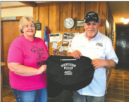Connie Gomez and Lynn Hamrick proudly display the bags that were donated to each of the 53 seniors by Hamrick’s Automotive Center for the Senior Gift Basket Project.