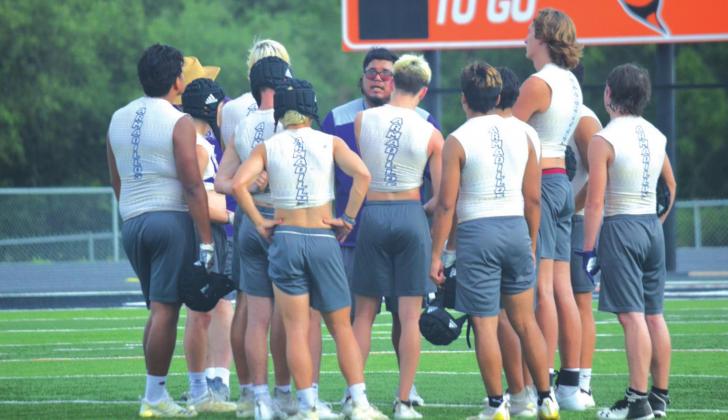 Pictured at right: San Saba High School varsity football head coach Andreas Aguirre (center) talks to a group of his players on Wednesday, June 15th, following a Dillos 7-on-7 summer scrimmage held at Llano High School. Photos by Andrew Salmi