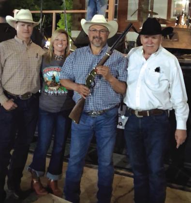 Gabriel Basquez was the winner of the 22 Lever Action Henry Golden Boy presented by Lynn Hamrick and donated by Mesquite Country Lodge, Hamrick's Bailbonds &amp; Lee Hoffpauir. Also in the photo is Lynn’s daughter, Leslie Edens and her boyfriend, Wes Hooper. Courtesy of Hamrick’s Automotive Center