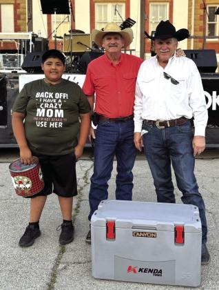 Lynn Hamrick presented Bill Jones from San Saba a Canyon Cooler. This prize was donated by Gateway. Also in photo is Manuel Ferrer (son of Hamrick's Automotive employee Alisha Ferrer) who helped with the event. Courtesy of Hamrick’s Automotive Center
