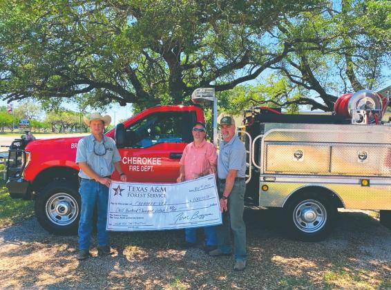 Shown are Cherokee VFD Fire Chief, Rodney Johnson; Department President, Keith Davis; and Texas A&amp;M Forest Service Regional Fire Coordinator, Matthew Schlaefer, holding a replica check designating the $100,000 cost sharing grant provided by the Rural Volunteer Fire Department Assistance Program administered by Texas A&amp;M Forest Service.