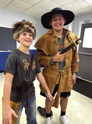 Pictured to the left are Uriah Valdez and Kyson Shanklin. Uriah is a 7th grade Texas History student at Cherokee ISD. He wears a hunter’s frock and slouch hat, and carries a flint lock hoping to put some food on the 1820 settlement table. Kyson is a 4th grade Texas history student at Cherokee ISD, and he wears a coonskin cap and a “possibles bag” which he hopes carries all he could possibly need for a hunting expedition. Students received a hands-on history from the Daughters of The Republic of Texas.
