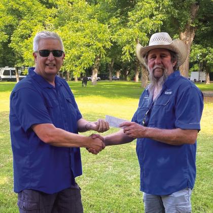 Cherokee Home for Children was blessed by a $1,263 donation by the San Saba County Cow Camp Cook-Off. Shawn Hull is seen here accepting the check on behalf of the Cherokee Home for Children from Larry Davis. San Saba County Cow Camp Cook-Off took place June 12th - 13th.