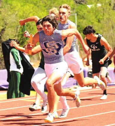 San Saba High School boys varsity track and field athlete Reagan Mejia (front) accelerates after taking the baton from Dillos teammate Drake Bryant (back) on Friday, April 8th, during the boys’ 4x100-meter relay event at the District 29-2A meet hosted by Mason High School. (Photo by Rita Boultinghouse)