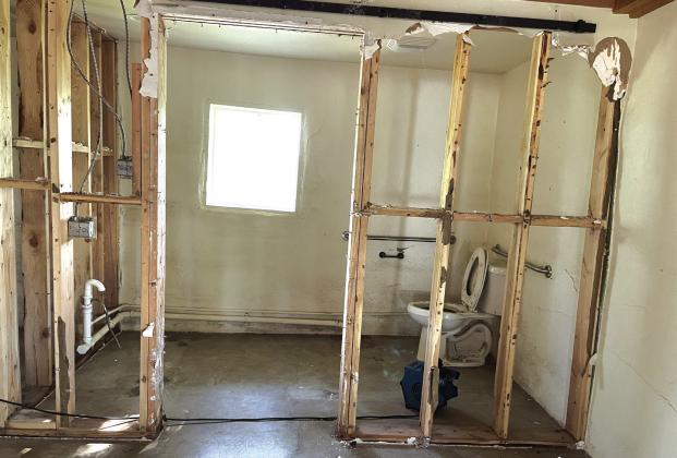 Storeroom on the left;restroom right. Materials stored all were thrown away. Cabinet gone in restroom.