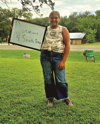 Rayleigh Perry from Burleson holding her “Donations 4 South Texas” Lemonade Stand sign