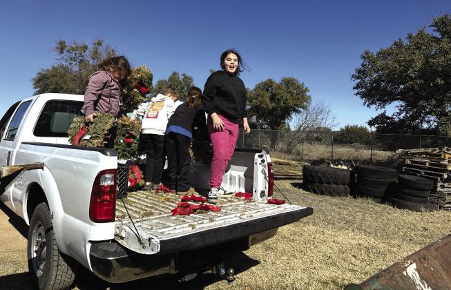 Cherokee ISD GT members Phoebe Valdez, Jaxon Owen, Addie Merriman, and Leilani Aguilar removed old wreaths from the cemetery as a community service project. Courtesy Shannon Padgett