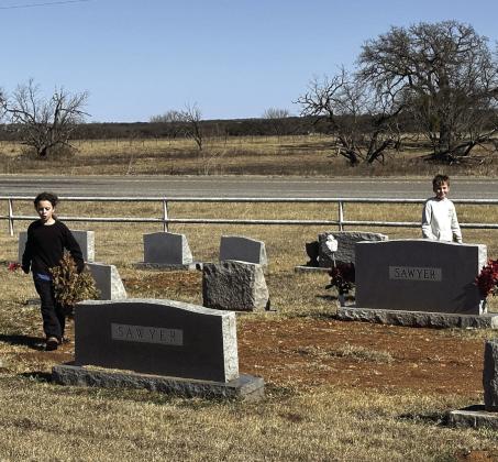 Cherokee ISD GT members Addie Merriman and Jaxon Owen removed old wreaths from the cemetery as a community service project. Courtesy Shannon Padgett