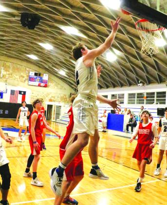 Everyone watches in awe as #2 Connor Womack floats up to the basket.