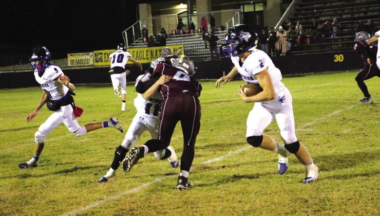 #2 Keston Lusty gets some yardage with the help from teammates.