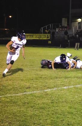 #2 Keston Lusty carrying the ball, #11 Kenny Triplett with the block, and #9 Hutton Rogers also in the frame going for a block.