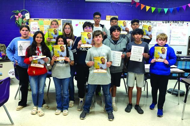 7th graders showing their completed St. Jude Math-A-Thon booklets Photos by Rebecca Owen