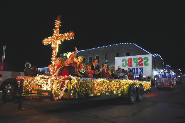 San Saba's First Baptist Church Kids waving at parade goers watching in wonder