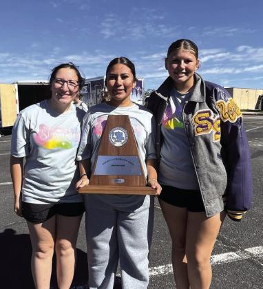 Drum Majors Emily Council, Ximena Cuevas and Zoey Turner holding the trophy. Courtesy of Misty Moellendorf