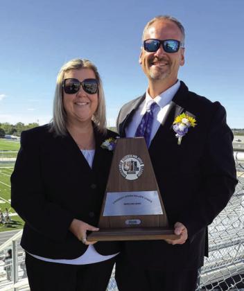 Band Directors Chans and Misty Moellendorf holding the trophy.