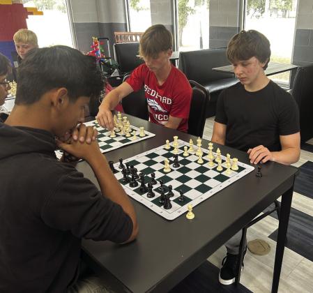 Kam (black hoody) Vince( red T-shirt) CJ (black T-shirt)