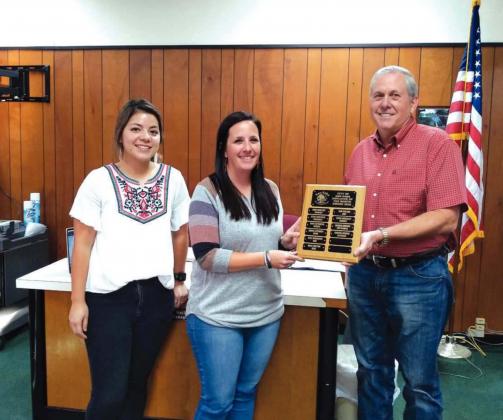 Shayna Norris, Utility Clerk, displays an Employee of the Month plaque with her name engraved for selection as the City's Employee of the Month for October. She also received a gift certificate to a local restaurant. At Shayna’s right is her supervisor, Bridgett Macedo - Utility Billing Supervisor, and to her left is Mayor Ken Jordan. (Photo by Djuana Payton)
