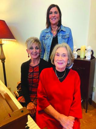 Right: Kay Nettleship and Leah Oehrlein welcomed Denise Wendel to the Pierian Christmas Tea where she entertained members with holiday piano selections.