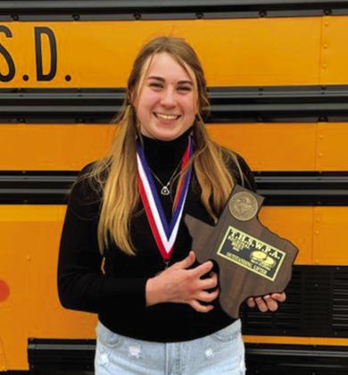 Austyn Graham holding her plaque for being the outstanding lifter at the Regional Powerlifting meet in her division.