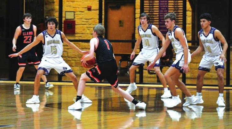 San Saba High School boys varsity basketball plays defense on Tuesday, December 7th, during the Dillos’ 57-36 home win against Llano High School. Players from left to right: senior guard Reagan Mejia (15), sophomore forward Lane Miller (11), senior guard Drake Bryant (24), and senior guard Franco Franco (10). (Photo by Rita Boultinghouse)