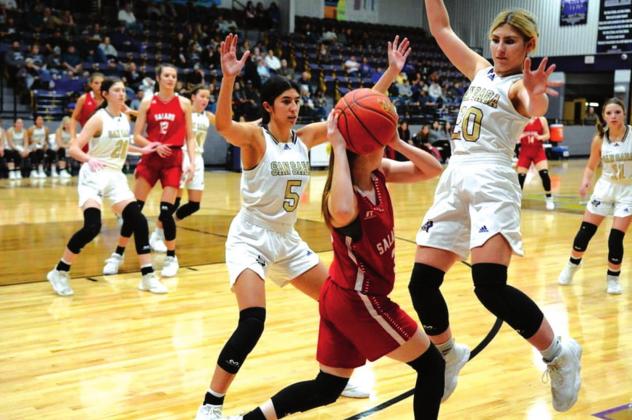 San Saba High School girls varsity basketball senior forward Nojemi Martinez (5) and senior guard Jaedah Lambert (20) play tight defense on Tuesday, December 7th, during the Lady Dillos’ 53-30 home victory vs. Salado High School. (Photo by Rita Boultinghouse)