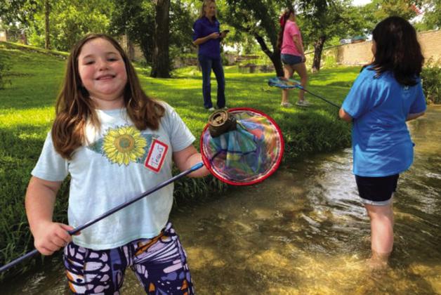Kids Nature Kamp photo from the past showing children learning about litter prevention. Courtesy of Keep Texas Beautiful