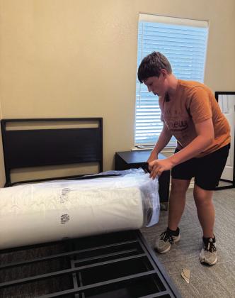 Lee unrolling a mattress