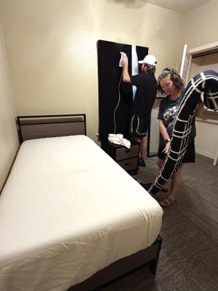 Merrick and Melanie steaming curtains and making beds