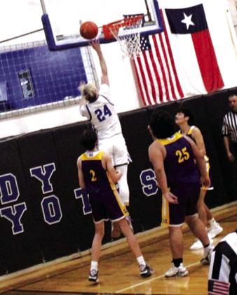 #24 Troy Kubin is seen here floating in the air to help snag the 75-30 victory over Mullin for the Coyotes.