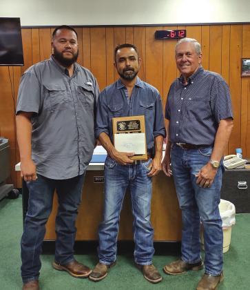 Sanitation Department employee Jose Rocha is proudly holding the Employee of the Month plaque with his name engraved on it. He was also given a gift certificate to a local restaurant. Taking part in the award presentation were Jose's supervisor, Juan Montoya on his right, and Mayor Ken Jordan on his left. Way to go, Jose!