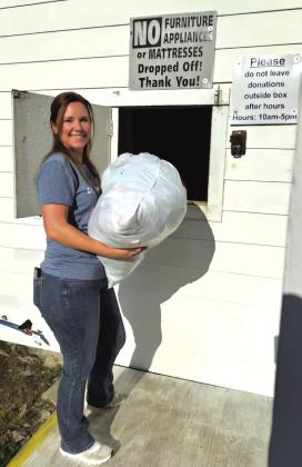 Shared Blessings employee Miranda Uli is showing you where to donate. This window is located in the back of the building.