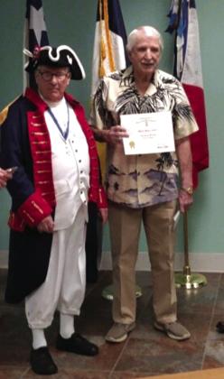 Wayne Gatliu receiving his Sons of the American Revolution membership certificate