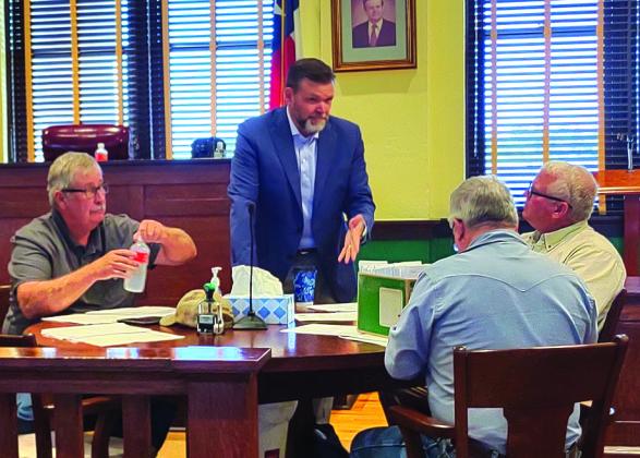 Judge Jody Fauley talking with Commissioners before Monday’s meeting.