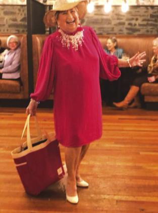 Anita Adams took part in the modelling show and then performed a skit to keep a smile on everyone's face at the Pierian Club November meeting.