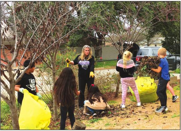 Kelley Cash, teacher, and students at the Elementary school garden.