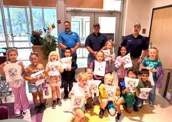 Members of San Saba Lodge #612 shown with the first graders (back row) are Alan Schroeder, Mason Murr, and Jake Lackey