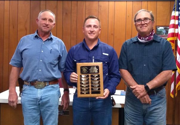Jacob Uptain, Electric Department employee, displays an Employee of the Month plaque with his name engraved for selection as the City's Employee of the Month for November. He also received a gift certificate to a local restaurant. At Jacob's right is Electric Department Supervisor, Denver Daniel, and on his left is Robert Whitten, Mayor Pro-Tem, taking part in the formal presentation. (Photo by Djuana Payton)