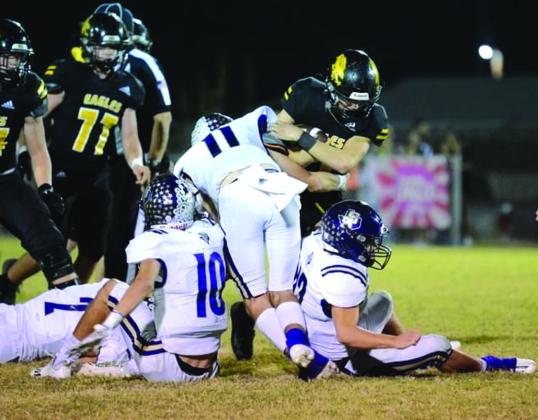 Another team tackle by Miller, Glover and Lackey. Go Team! Courtesy of Rita Boultinghouse