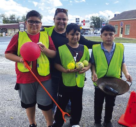 5th grade volunteers Eli Perez, Ezequiel Garcia &amp;amp; Jose Luis Morales, Jr. pictured with Juanita Rocha. Courtesy of Sarah Saldivar