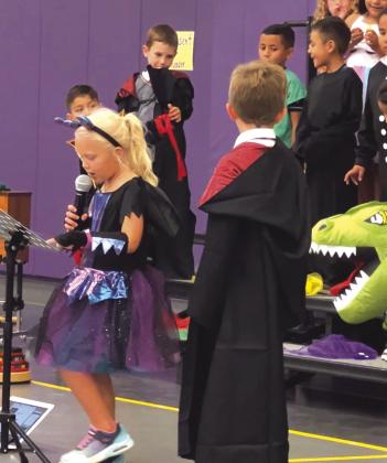 First Grader Vivian Theis speaking between songs