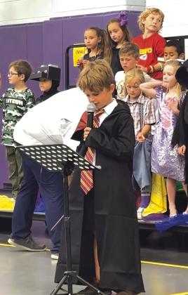 First Grader Turner Henslee speaking between songs